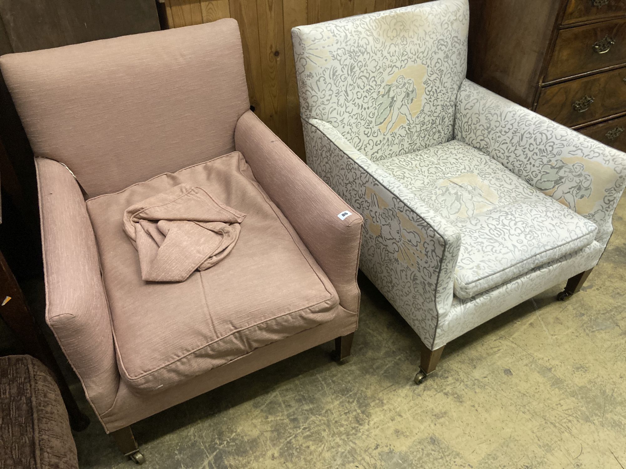A pair of Edwardian Howard & Son upholstered square framed armchairs with stamped legs and casters, width 69cm, depth 70cm, height 78cm